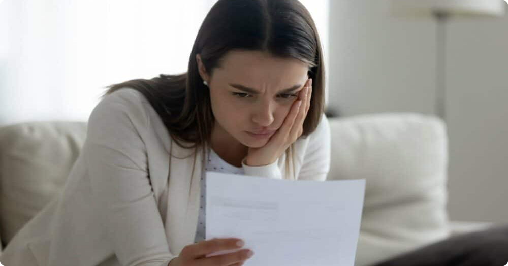 young-female-landlord-reviewing-bad-tenant-list.png